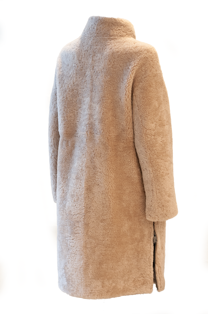 Dark beige Filuka curly lamb coat on a mannequin, rear three-quarter view showing the high collar and side zip