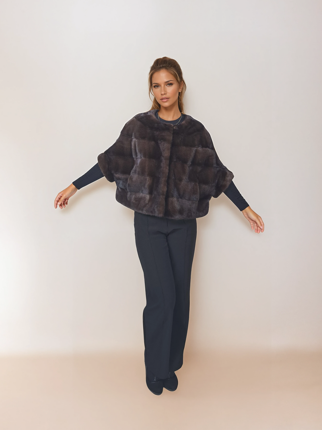 Front view of a model wearing Tulle in brown mink with arms extended.