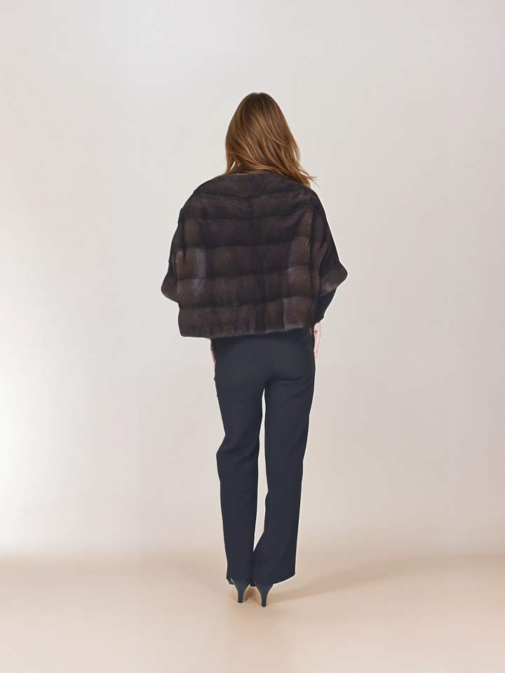 Back view of a model wearing Tulle in brown mink, styled with black pants.