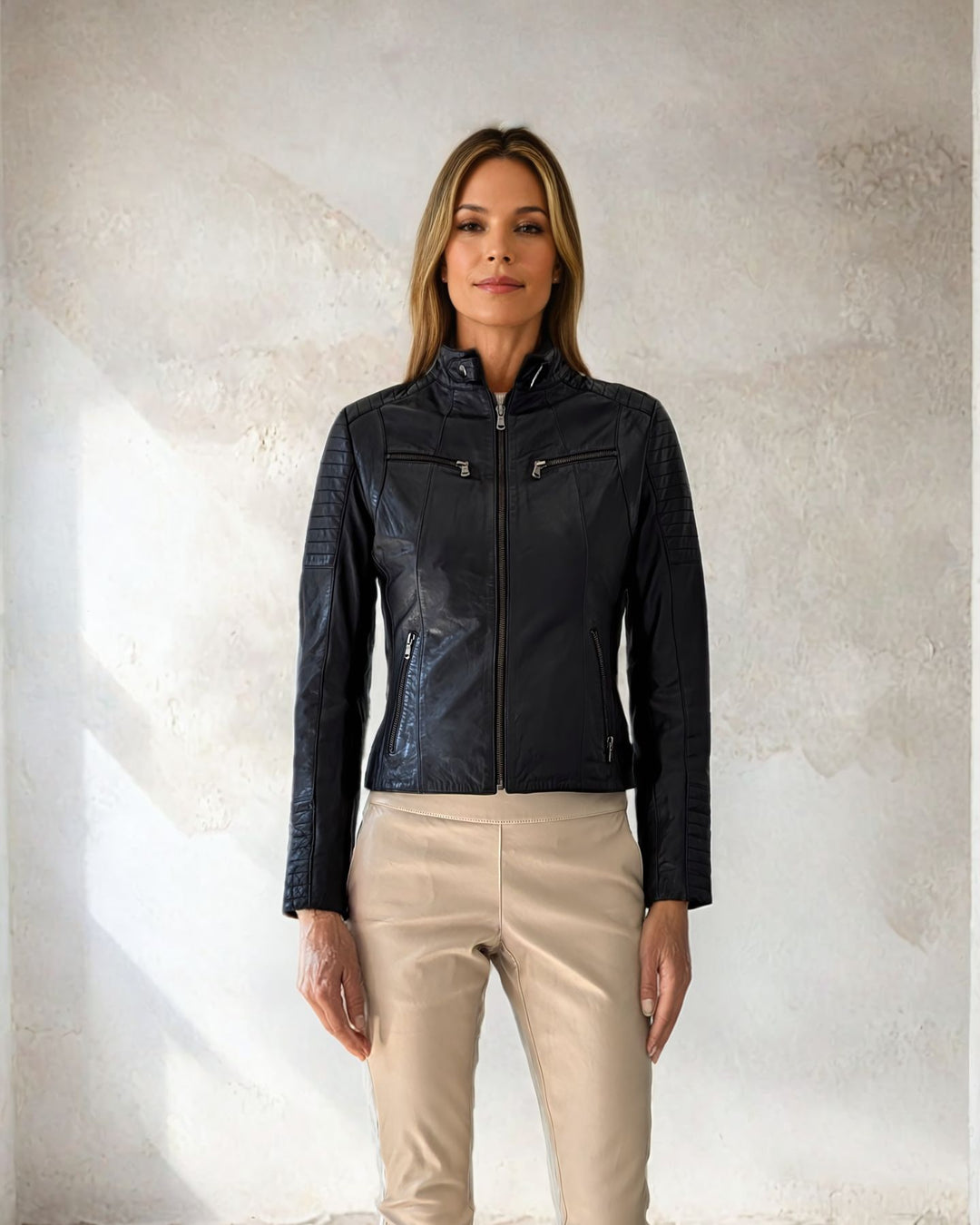 Model wearing the Scooty black lambskin biker jacket zipped closed, front view showing chest pockets and quilted sleeves