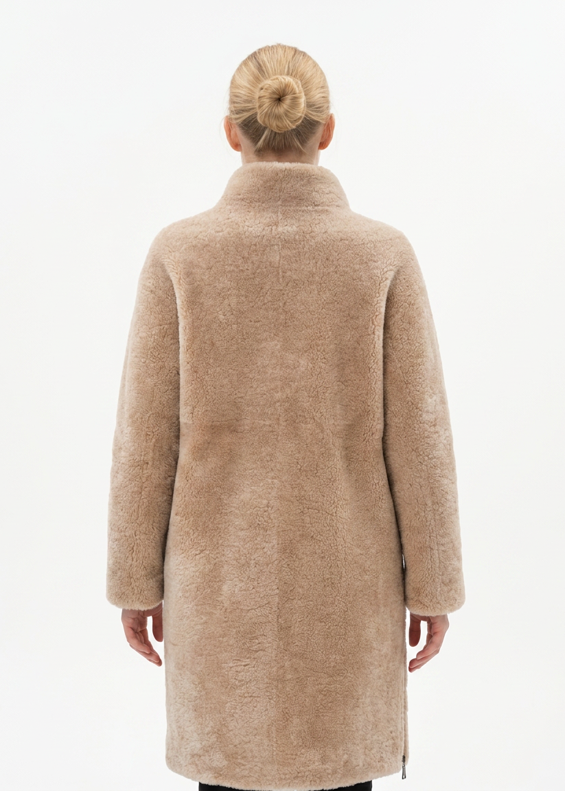 Model wearing the dark beige Filuka curly lamb coat with a high collar, back view
